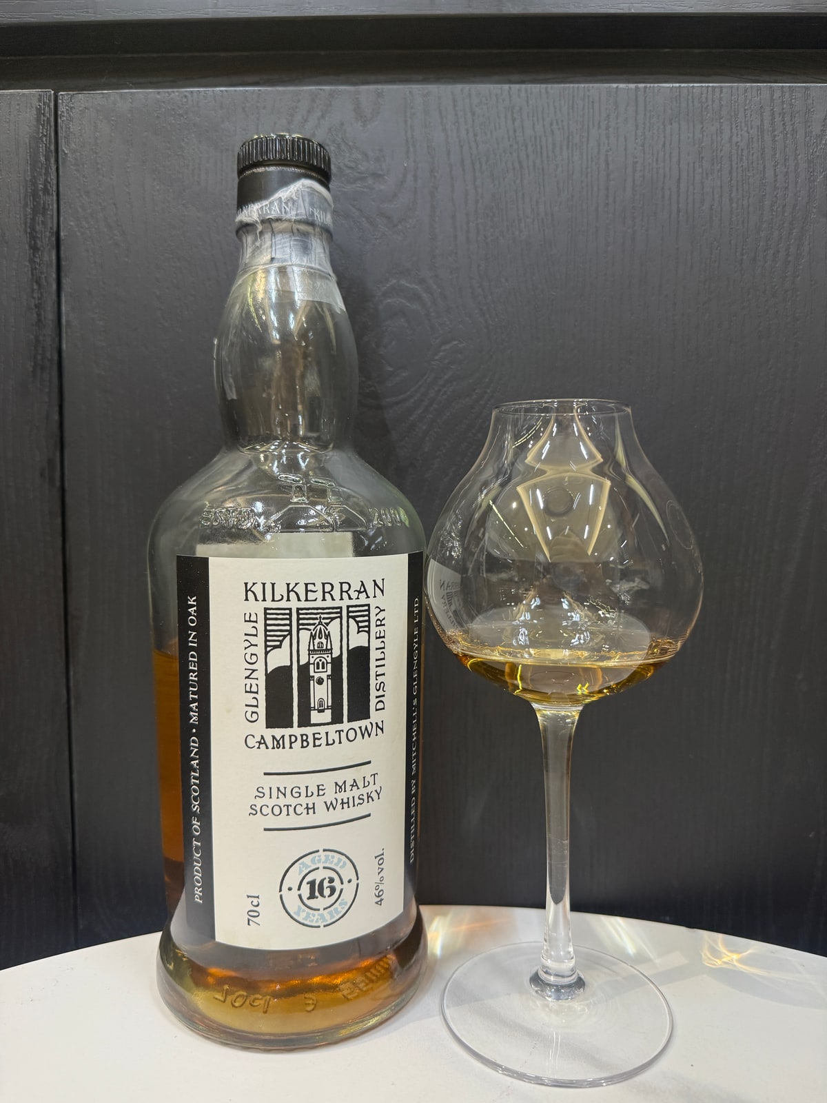 Illustrative image · Illustrative client photo of Kilkerran 16, 46%. The 2024 batch year is not visible or verified in this frame. Bottle and glass shown; full original retained.