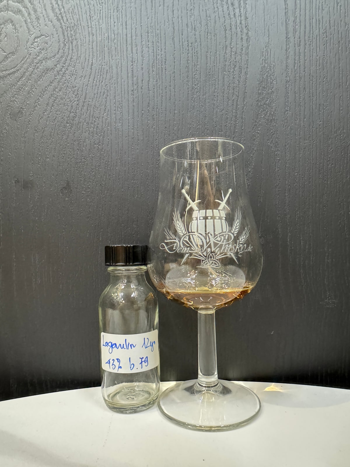 Handwritten sample label: Lagavulin 12/43%, b.79; no factory bottle shown. | Client