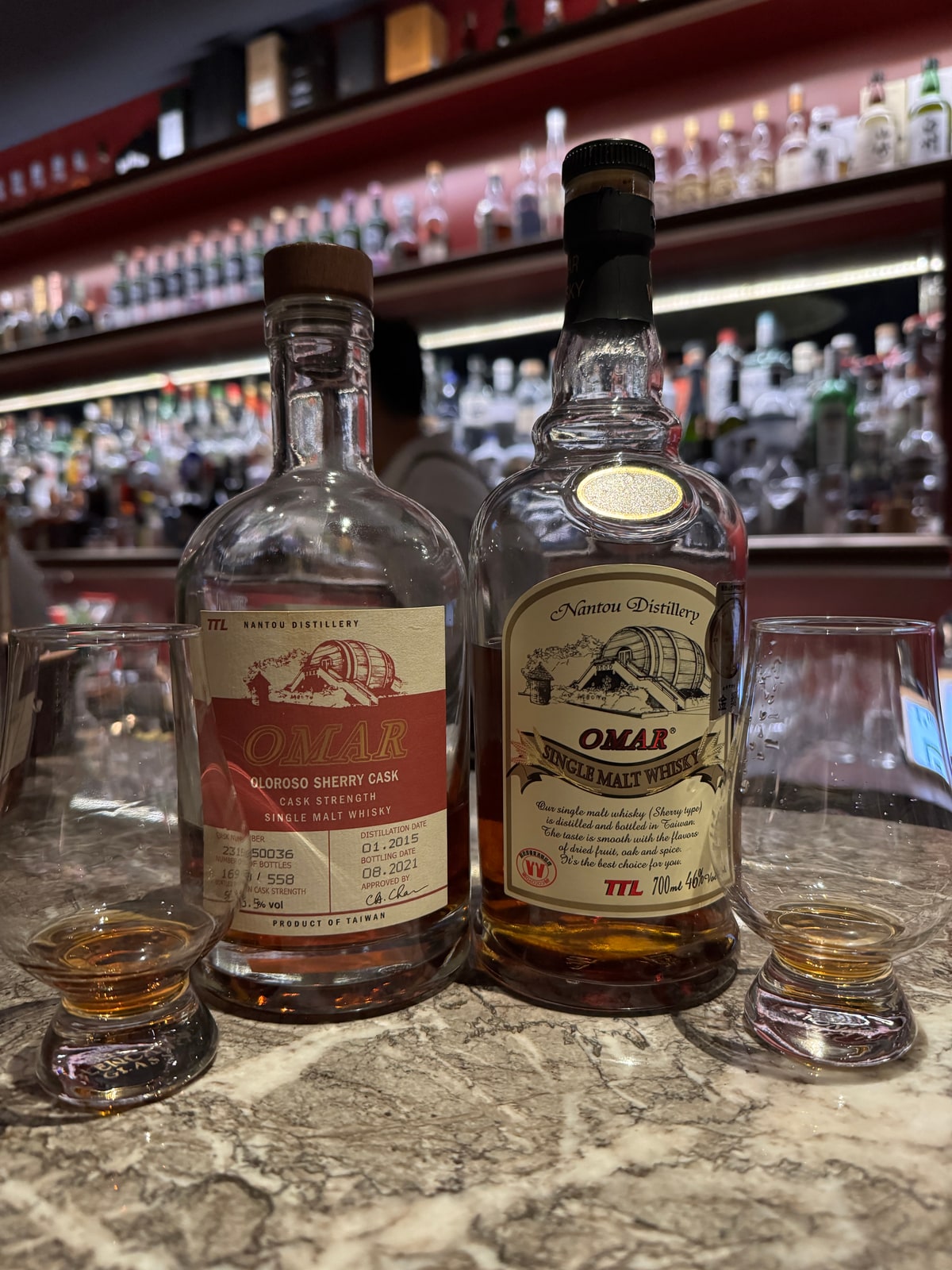 Illustrative image · Illustrative client photo: LEFT Omar Oloroso cask-strength 2015/2021; strength partly obscured. RIGHT standard 46% bottle is not the target; glasses and whole background retained.