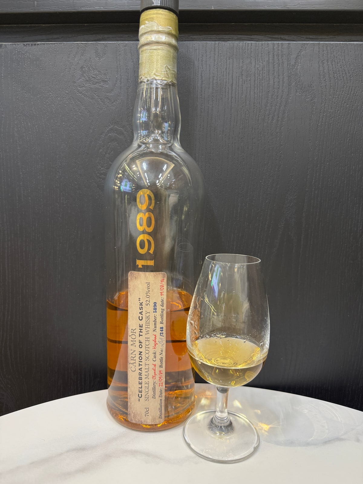 Illustrative image · Illustrative client photo: Carn Mor Clynelish 1989/2014, 52%, cask 5880, with glass. The review names cask 5890, so this is not its exact cask. Whole original frame; bottle top is cut off.