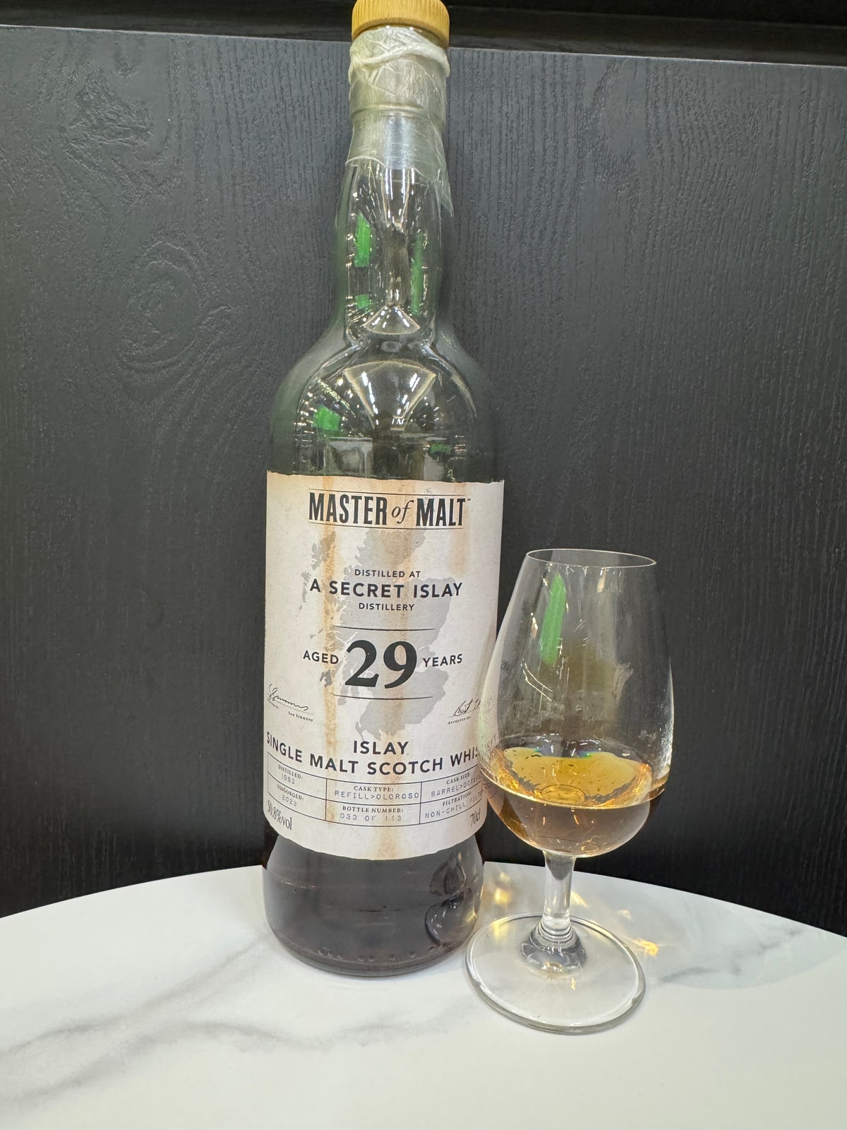 Illustrative image · Illustrative client photo: Master of Malt A Secret Islay, 29 years, 50.8%, with glass. Same product line; a different strength from the reviewed 51.7%. Whole original frame.