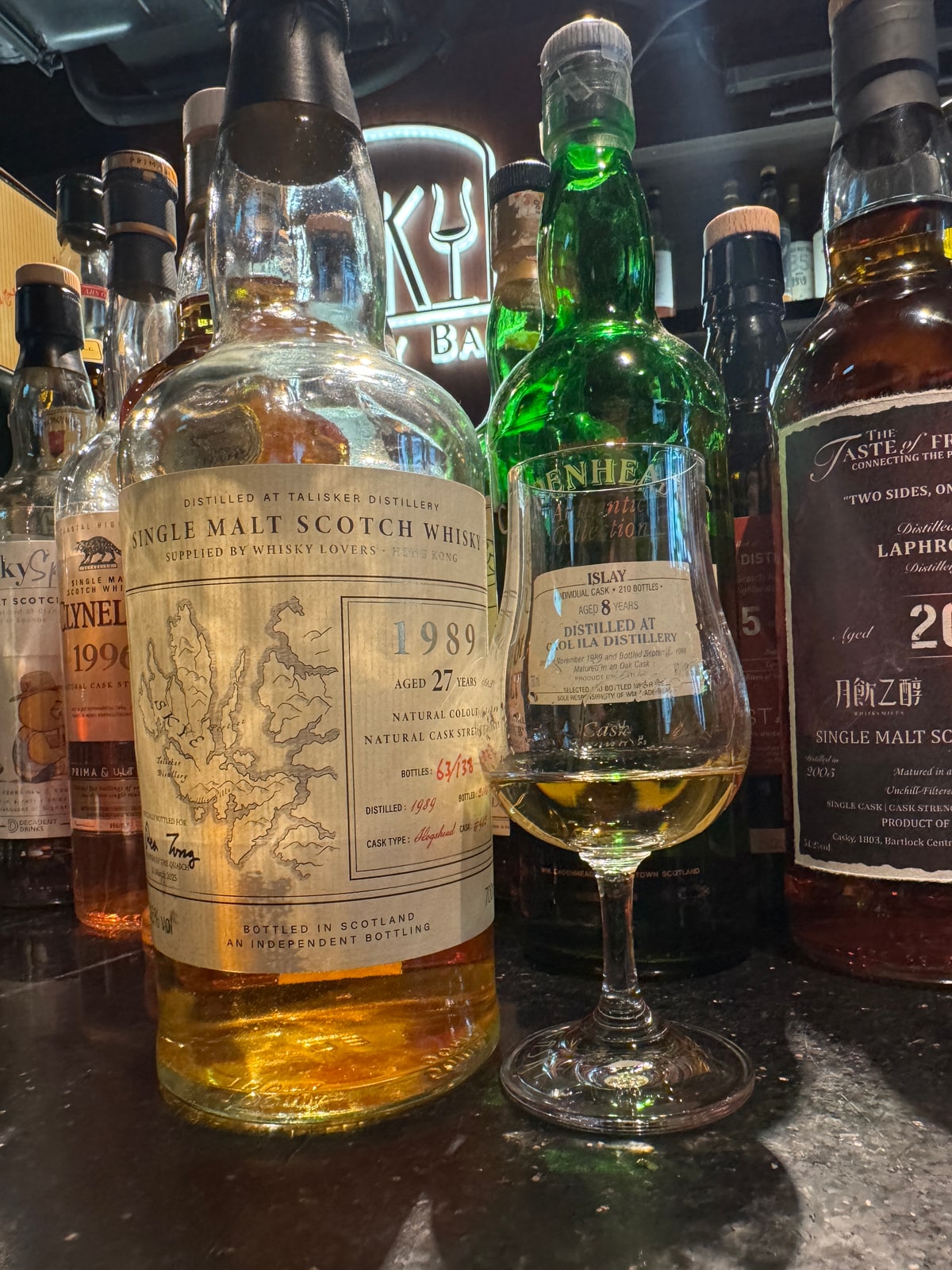 Client-supplied Talisker 1989, 27 years, 51.6% for Rex Tong / Whisky Lovers Hong Kong in the left foreground; hidden strength corroborated by the exact critic catalogue.