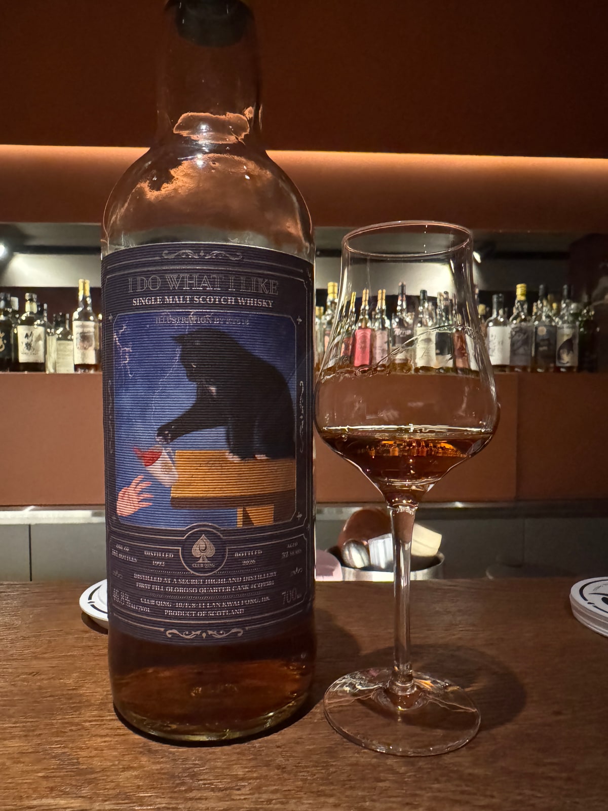Illustrative image · Illustrative client photo: Club Qing Secret Highland 1993/2026 with glass; Clynelish identity unverified. Bottle top cut off in the original.