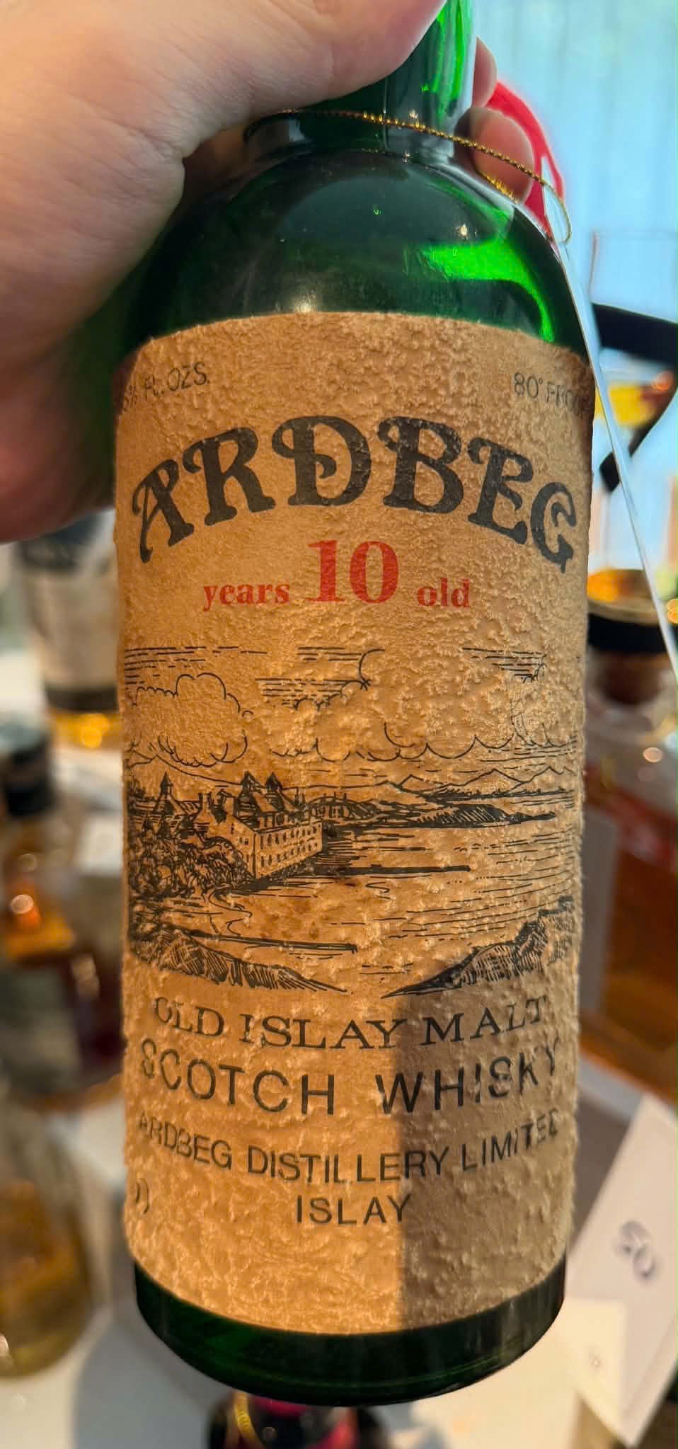 Client photo: Ardbeg 10 years; bottle view. Handheld or close view; bottle top may be outside the frame.
