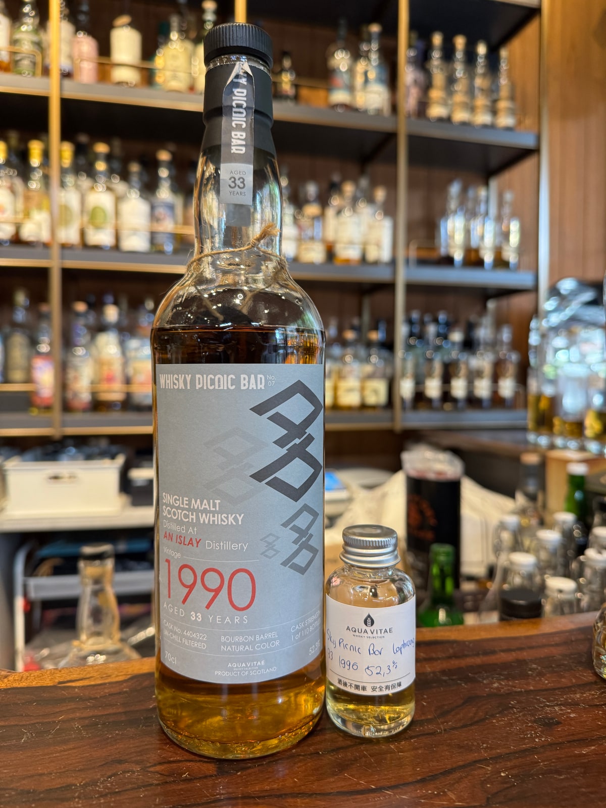Client-supplied Whisky Picnic Bar undisclosed Islay 1990/2024, 33 years, 52.3%, cask 4404322 in the left foreground; hidden bottled year corroborated by the exact critic catalogue; right sample excluded.