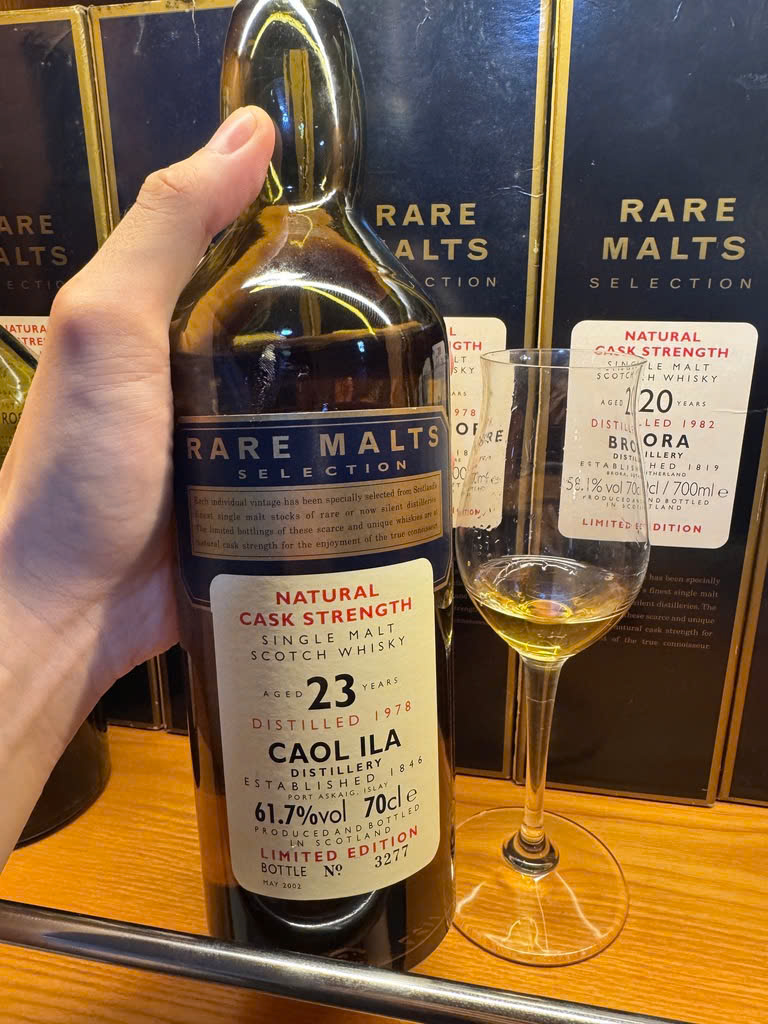 Client photo: handheld Rare Malts Caol Ila 1978, 23 years, 61.7%, with glass; bottle top cut off.