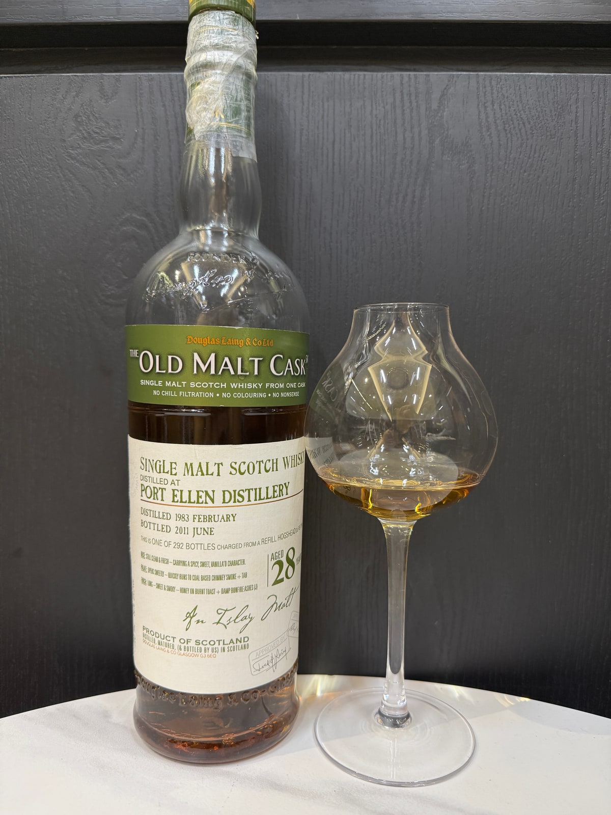 Client-supplied foreground bottle photo of Douglas Laing Old Malt Cask Port Ellen 1983 2011 28 Years Old 50% Cask DL 7244.